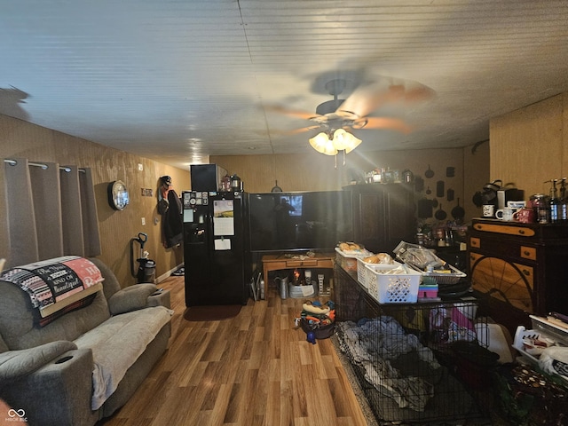 living area featuring ceiling fan and wood finished floors