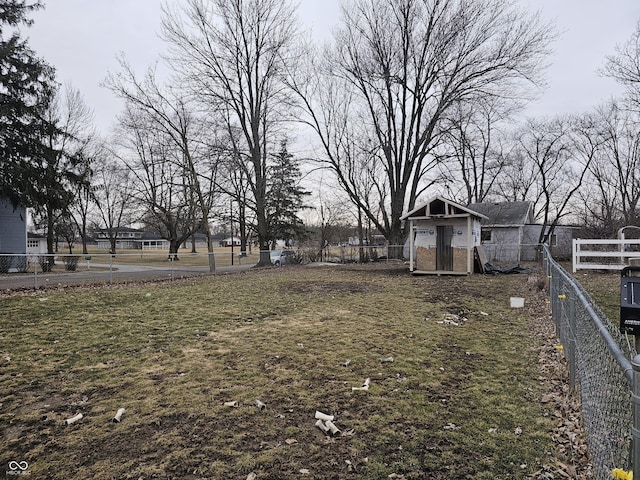 view of yard featuring an outdoor structure and fence