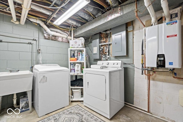 laundry room featuring laundry area, electric panel, separate washer and dryer, and water heater