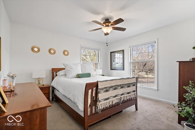 bedroom featuring a ceiling fan, baseboards, and light carpet