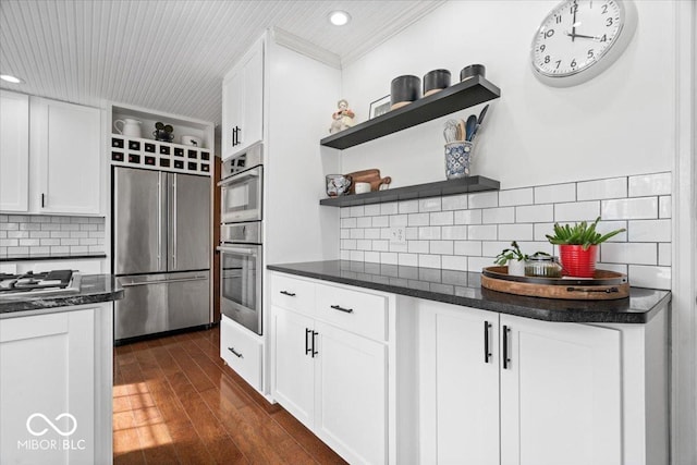 kitchen with open shelves, tasteful backsplash, dark wood finished floors, white cabinetry, and appliances with stainless steel finishes