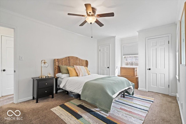 bedroom featuring baseboards, carpet floors, multiple closets, and crown molding