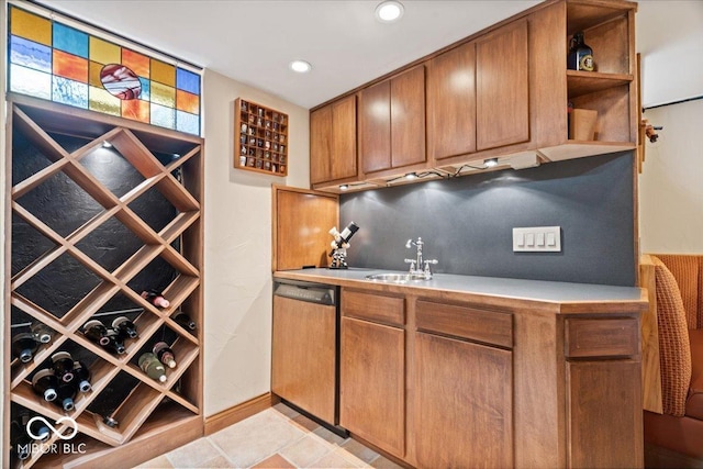 wine room featuring a sink, baseboards, and recessed lighting