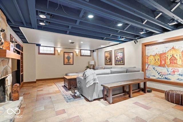 living room featuring stone finish floor and baseboards