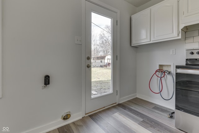 doorway to outside featuring light wood-style floors and baseboards