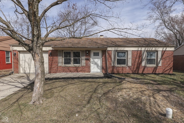 single story home featuring a front yard, an attached garage, brick siding, and driveway