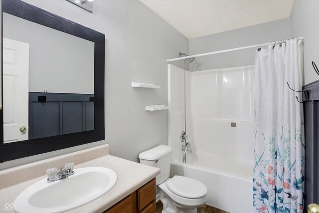 bathroom featuring toilet, a textured ceiling, vanity, and shower / bathtub combination with curtain