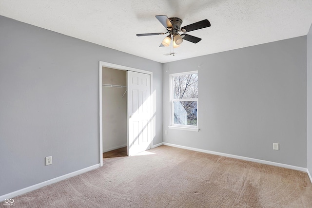 unfurnished bedroom featuring a closet, baseboards, carpet, and a textured ceiling