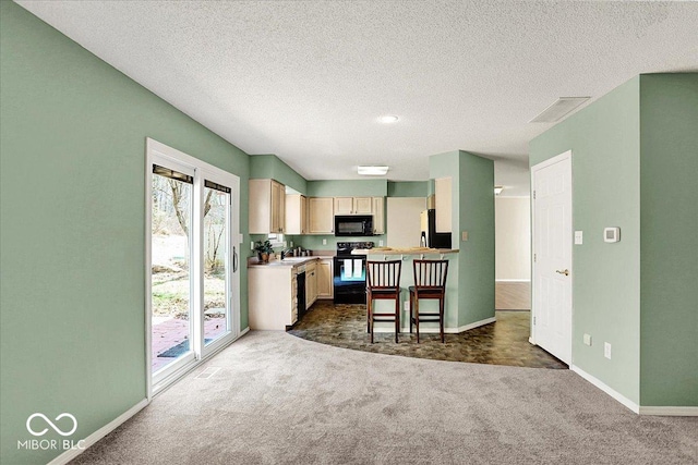 kitchen featuring black appliances, light countertops, baseboards, and dark carpet