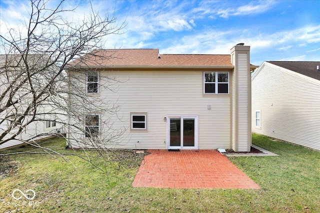 rear view of property featuring a patio area, a lawn, and a chimney