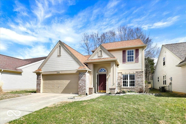 traditional-style home featuring a front lawn, a garage, brick siding, and driveway