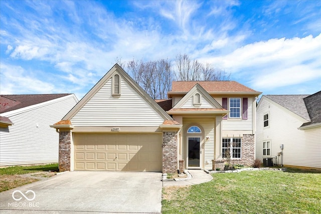 traditional-style home featuring a garage, brick siding, concrete driveway, and a front lawn