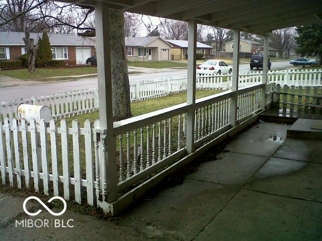 exterior space with a fenced front yard and a residential view