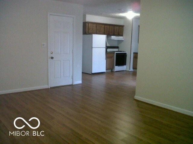 interior space featuring dark wood-type flooring and baseboards