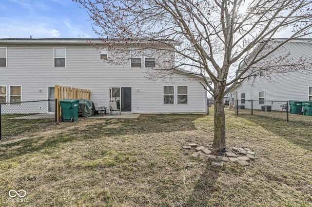 back of property with central AC unit, a yard, a patio area, and a fenced backyard