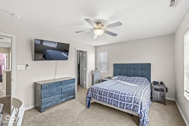 bedroom with multiple windows, carpet flooring, baseboards, and ceiling fan