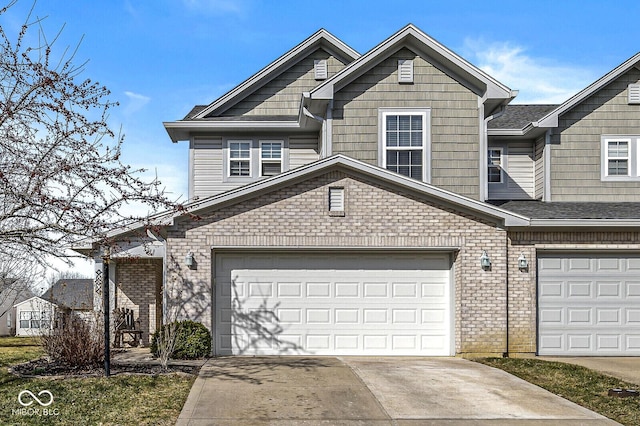 view of front facade with brick siding, an attached garage, concrete driveway, and a shingled roof