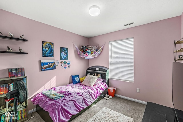 bedroom with visible vents, baseboards, and carpet