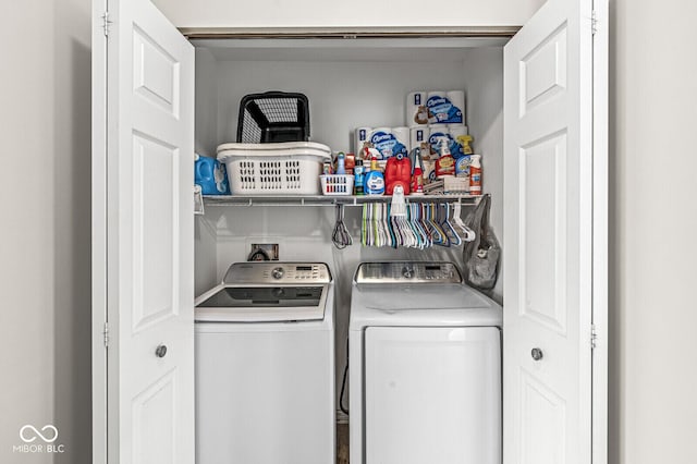 clothes washing area with laundry area and washer and clothes dryer