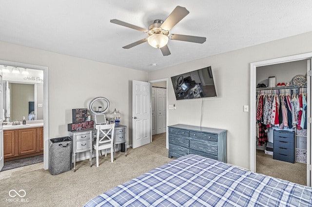 bedroom featuring a closet, light carpet, connected bathroom, and a spacious closet