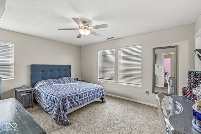 bedroom featuring visible vents, multiple windows, baseboards, and carpet flooring