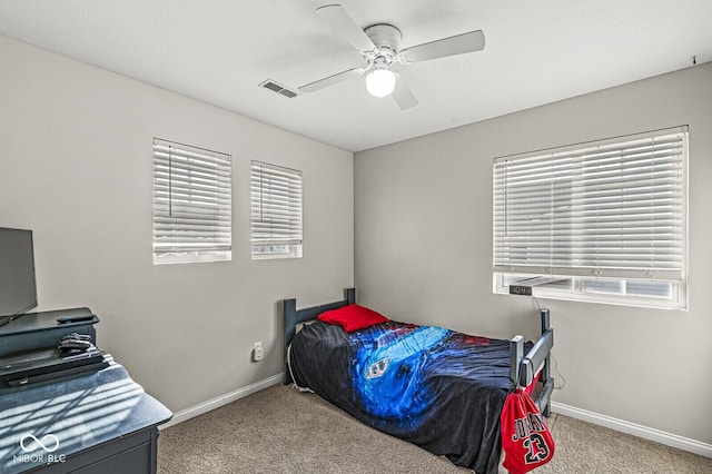 bedroom featuring visible vents, multiple windows, carpet, and baseboards