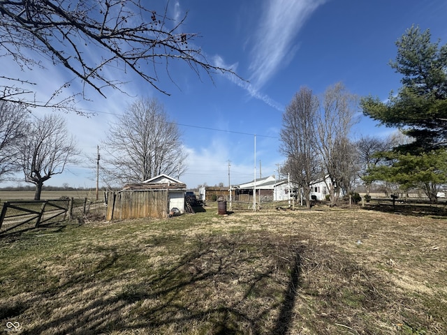 view of yard with an outbuilding and fence