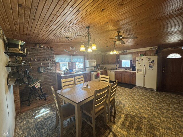 dining space with brick wall, wood ceiling, and ceiling fan