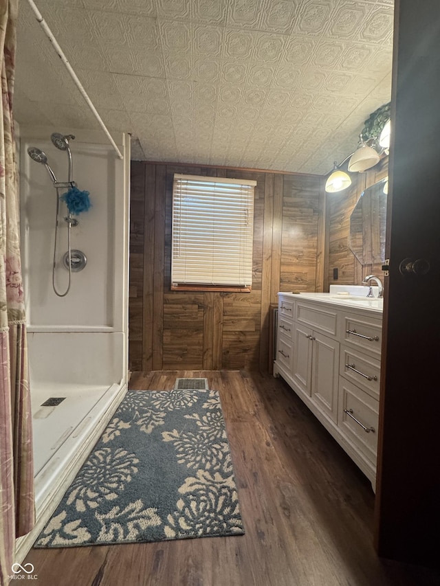 full bath featuring wooden walls, an ornate ceiling, and wood finished floors