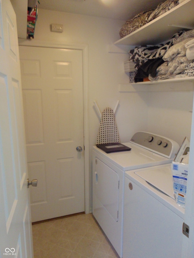 laundry room featuring separate washer and dryer and laundry area