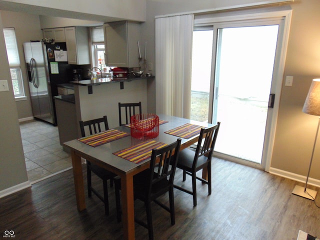 dining area with baseboards and dark wood-style flooring