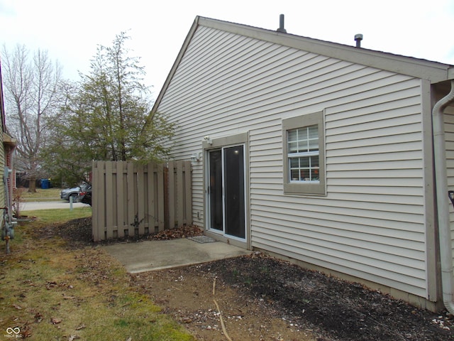 rear view of property featuring fence