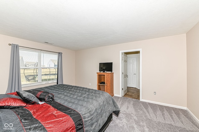 bedroom with carpet flooring, baseboards, visible vents, and a textured ceiling