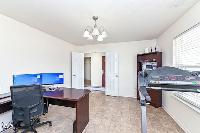 office featuring visible vents, baseboards, and an inviting chandelier