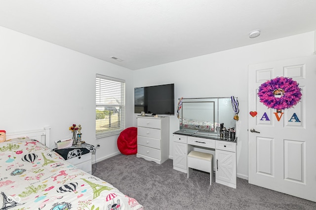 carpeted bedroom featuring visible vents and baseboards