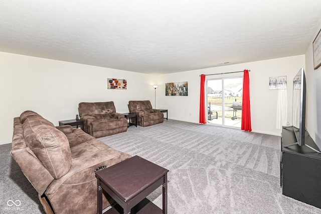 carpeted living room featuring a textured ceiling and baseboards