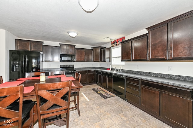 kitchen featuring dark countertops, dark brown cabinets, black appliances, a textured ceiling, and a sink