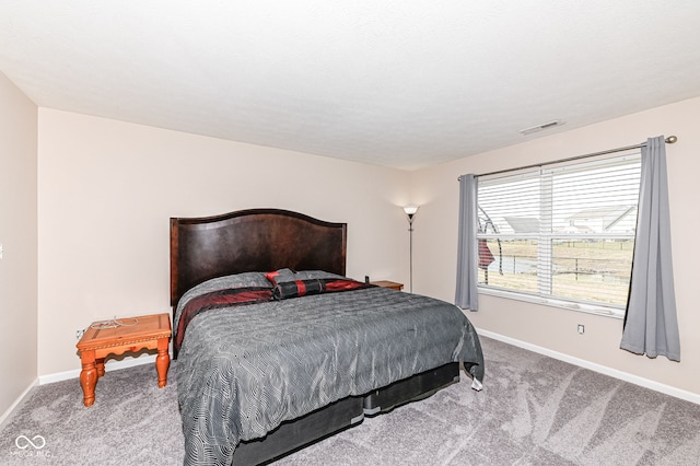 bedroom with visible vents, carpet floors, and baseboards