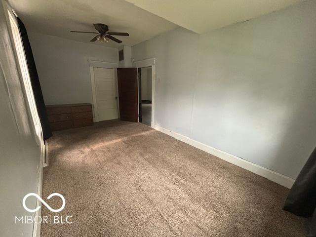 1713 Charles St, Lafayette, IN 47904 - empty room with ceiling fan, carpet floors, and baseboards