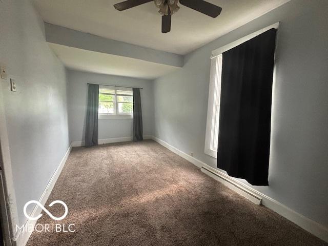 1713 Charles St, Lafayette, IN 47904 - spare room with ceiling fan, carpet floors, a baseboard heating unit, and baseboards