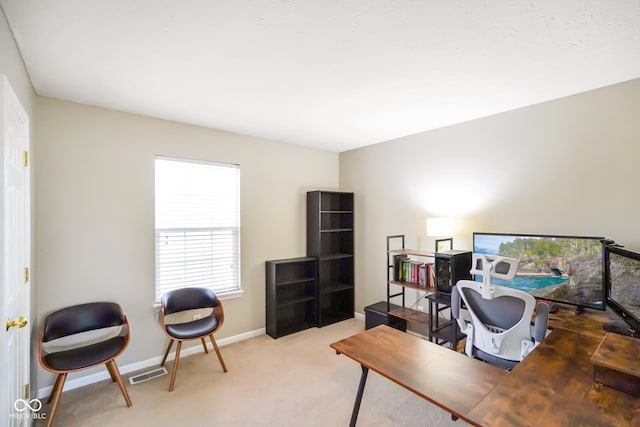 carpeted office featuring baseboards and visible vents