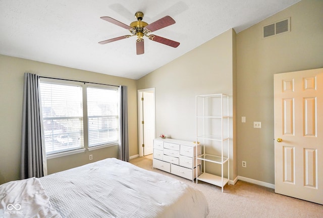 bedroom featuring visible vents, light carpet, a textured ceiling, baseboards, and vaulted ceiling