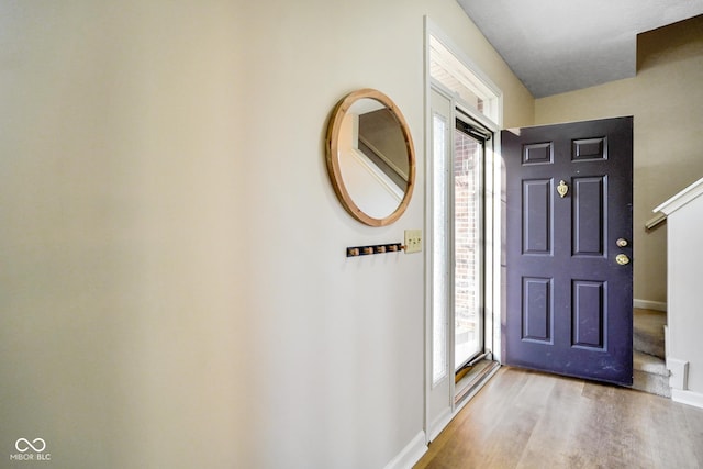 entrance foyer with wood finished floors and baseboards