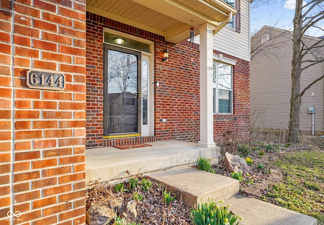 doorway to property with brick siding