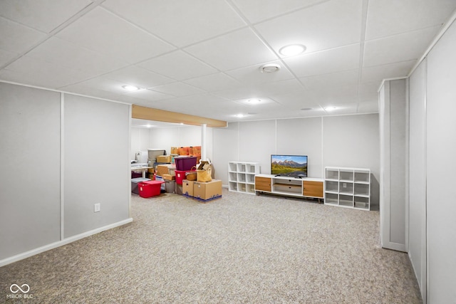 playroom with a drop ceiling, carpet floors, and a decorative wall