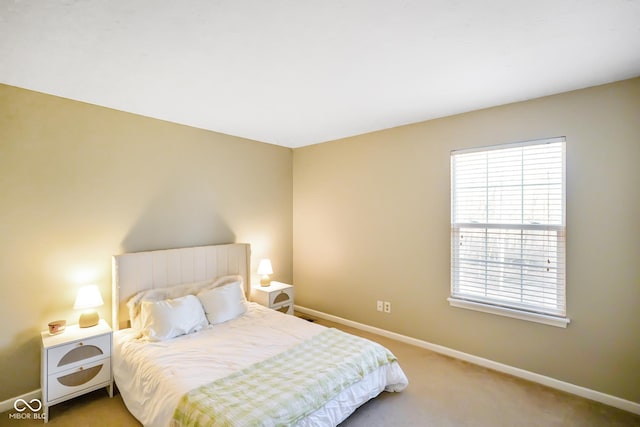 carpeted bedroom with baseboards