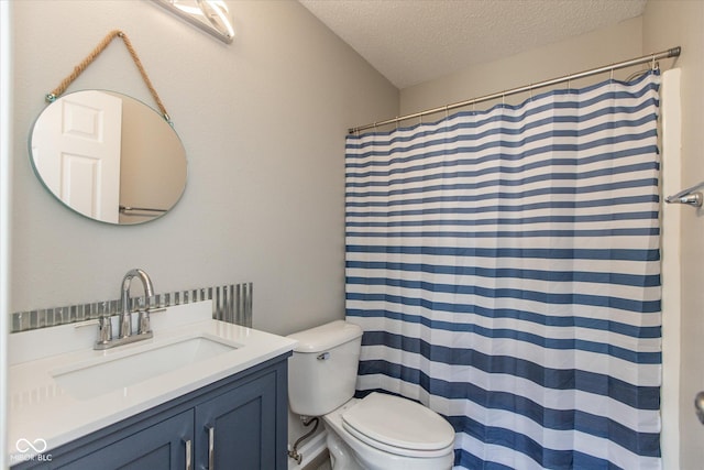 bathroom featuring vanity, toilet, a shower with curtain, and a textured ceiling