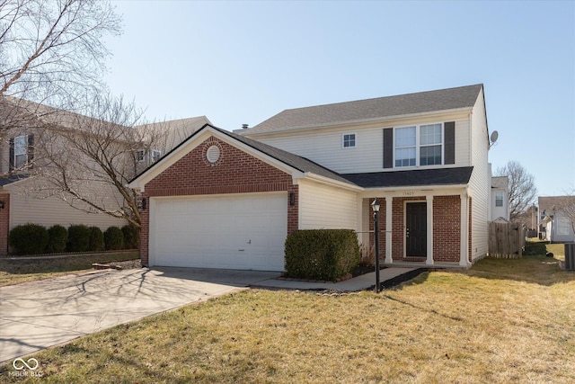 traditional-style house with brick siding, driveway, a front yard, and a garage