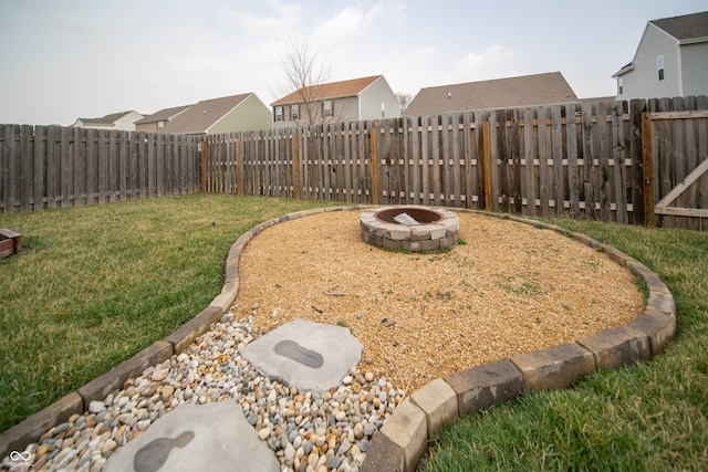 view of yard with a fire pit and a fenced backyard