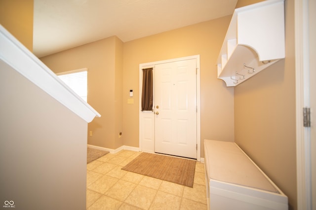 mudroom with light floors and baseboards